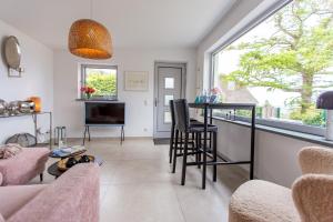a living room with a bar and a window at Haus Anna Atelier in Ahrenshoop