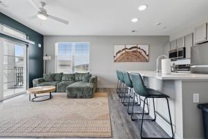 a kitchen and living room with a couch and a table at IRIE Living, Replenish Kg 2Bd Gym Pool BRAND NEW in Whitestown