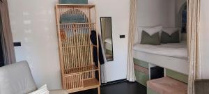 a room with a mirror next to a bed and a dog at Zeelucht in Zandvoort