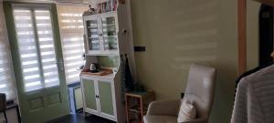 a room with a door and a chair and a window at Zeelucht in Zandvoort
