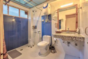 a bathroom with a toilet and a sink and a mirror at V V Aero a wooden exotic stay Near Old Manali in Manāli +20 photos