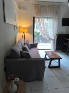 a living room with a couch and a table at Samothraki Echo Apartment in Alexandroupoli