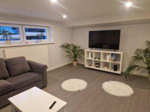 a living room with a couch and a flat screen tv at Leuchters Unterkunft in Bad Doberan