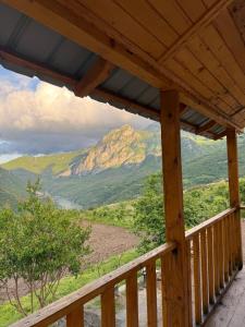 a wooden porch with a view of a mountain at Lekbibaj view in Tropojë
