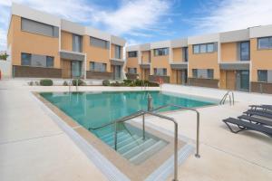 a swimming pool in front of a building at Casa El EDEN 39 in Mijas