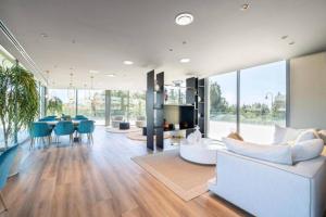 a living room with a white couch and a table at Casa El EDEN 39 in Mijas