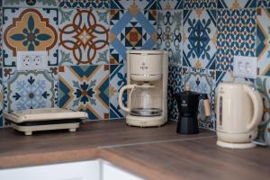 a kitchen counter with a coffee maker on a counter top at Leros Houses Sea View 2 in Lépidha