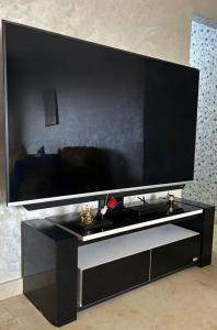 a large flat screen tv on a black entertainment center at 8 min from beach centre city founty neighbour in Agadir