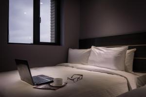 Postel nebo postele na pokoji v ubytování Yi Su Hotel-Taipei Ningxia