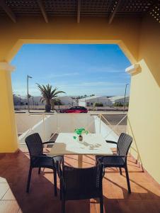 a table and chairs on a balcony with a view at Casa Min26 in Caleta De Fuste