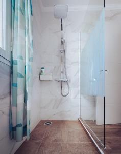 a bathroom with a shower with a glass door at Casa Min26 in Caleta De Fuste