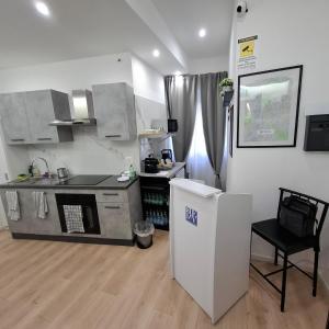 a kitchen with a stove and a refrigerator at Bemy in Rome