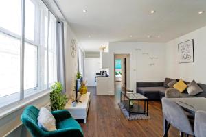 a living room with a couch and a table at Imperial Middlesex Street Apartments in London