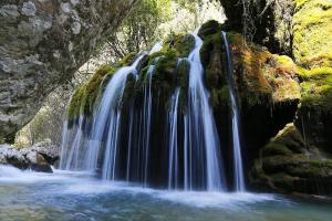a group of waterfalls pouring into a river at ROSALINDA - Borgo Experience Cilento in Casaletto Spartano +15 photos