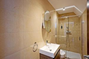 a bathroom with a sink and a shower at Imperial Middlesex Street Apartments in London +72 photos