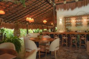 a restaurant with tables and chairs and a bar at Anzalik Hotel Boutique in Anzá