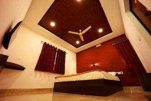 a bedroom with a ceiling with a clock on it at Cave Valley Wayanad in Ambalavayal