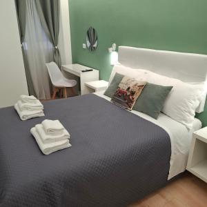 a bedroom with a large bed with towels on it at Bemy in Rome
