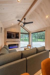 a living room with a couch and a ceiling fan at Black Prong Resort in Bronson