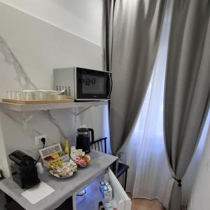 a kitchen with a table with a microwave and a curtain at Bemy in Rome +22 photos