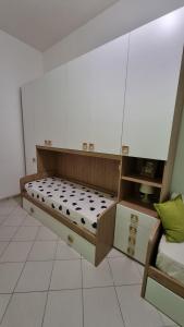 a bedroom with a bed and a dresser at La casa di Follonica in Follonica