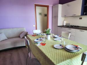 a table with plates and glasses on it in a living room at Michela's house in Capo Vaticano +29 photos