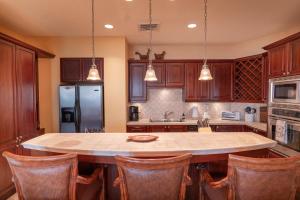 a kitchen with a large island with chairs around it at CR Luxury Terrazas De Marbella 3A 3 Bdrm in La Mona