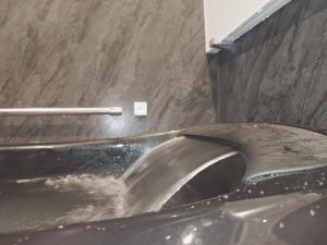 a metal toilet in a bathroom with a sink at Somnus豊田 ペットOK 最大宿泊人数12名!1棟貸切の宿 in Toyota +37 photos