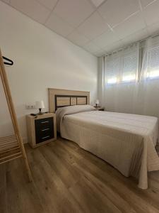 a bedroom with a large bed and a wooden floor at Apartamento tipo loft valencia in Paiporta