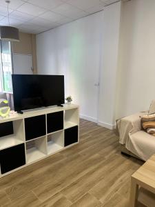 a living room with a flat screen tv on a white entertainment center at Apartamento tipo loft valencia in Paiporta