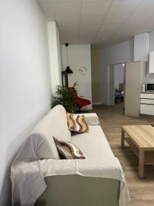 a living room with a couch and a table at Apartamento tipo loft valencia in Paiporta