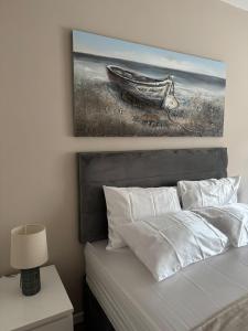 a bedroom with a bed with a painting on the wall at Sheffield City Centre - Westhill House Apartments in Sheffield