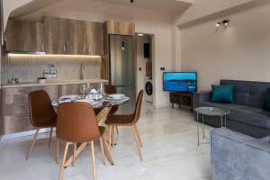 a kitchen and living room with a table and a couch at Zante way villas in Zakynthos