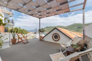 a balcony of a house with a view of the ocean at Blue Heaven Loft House in Skopelos Town