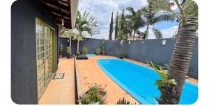 a swimming pool in the backyard of a house at Cantinho do Aconchego in Campo Grande