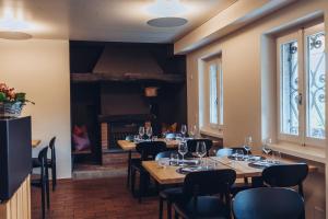 a dining room with tables and chairs and a fireplace at La Montanara in Casima