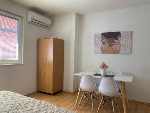 a bedroom with a bed and a table and chairs at Apartment Polkaposki Trpejca in Trpejca