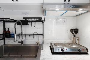 a kitchen with a sink and a stove at 100% Private, KingBed- SouthCoast/Newport/Disney in Costa Mesa +24 photos