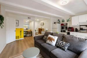 a living room with a couch and a kitchen at 100% Private, KingBed- SouthCoast/Newport/Disney in Costa Mesa