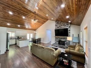 a living room with a couch and a fireplace at Cozy 3 BR Cabin with Pond on 3 acres - New River Gorge - Summersville Lake in Mount Lookout