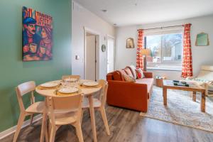a living room with a table and a couch at Le Nid Trailside 1BD Close to Beach Downtown in Traverse City