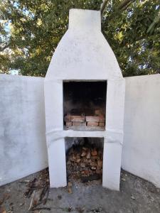 a white oven with a pile of bricks in it at Schalkenbosch Heritage Cottages in Tulbagh