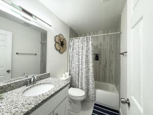 a white bathroom with a sink and a toilet at Home close to Clearwater beach in Largo +25 photos