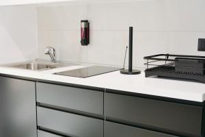 a kitchen with a sink and a counter top at BVsireneHOUSE in Polignano a Mare +41 photos