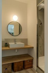 a bathroom with a sink and a mirror at Ocean View Apartment in Hossegor