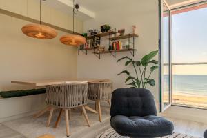 a dining room with a table and two chairs at Ocean View Apartment in Hossegor +2 photos