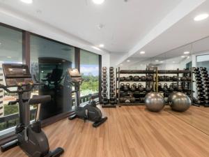 a gym with dumbbells and exercise equipment in a room at LVL43 Queens Wharf 1BR Apartment in Brisbane