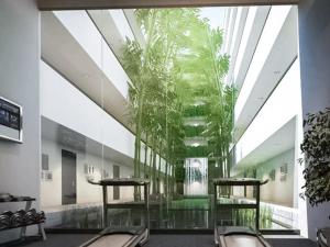 a lobby with a plant in the middle of a building at Exquisite Modern 1BR - Ultra Fast Wifi - BTS Thong Lo in Bangkok
