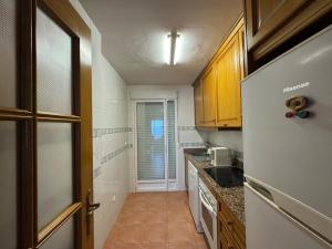 a small kitchen with a refrigerator and a window at Atico con vistas al mar in Mojácar