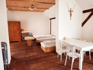 a white dining room with a table and a couch at Vila Hedvika in Nové Hrady